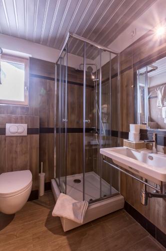 a bathroom with a shower and a toilet and a sink at Hotel Lirak in Tetovo