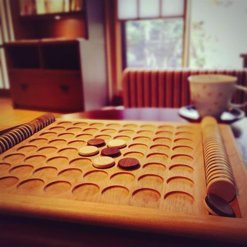 a wooden cutting board with buttons on a table at Muromachi Yutone Kyokoyado in Kyoto