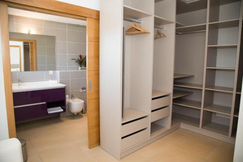 a bathroom with a sink and a toilet and a mirror at Casa Es Puig Redó ETV-1980-E in Sant Josep