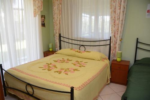 a bedroom with a bed with a bedspread on it at B&B Villa San Leonardo in Mascali