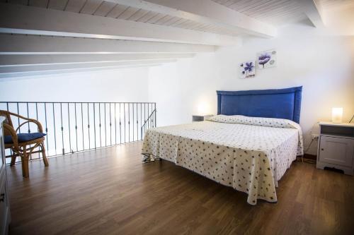 a bedroom with a bed and a table and a chair at Appartamento La Marina in Castellammare del Golfo
