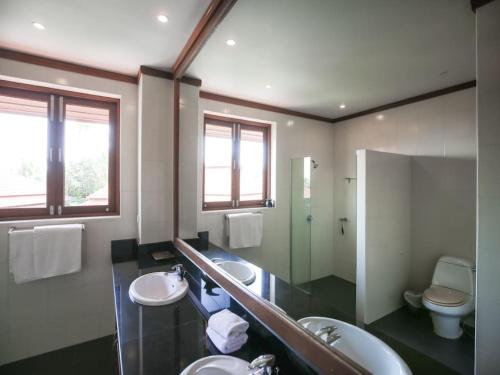 a bathroom with two sinks and a mirror and a toilet at 3 Bedroom Villa TG40 on Beach Resort SDV286-By Samui Dream Villas in Bophut 