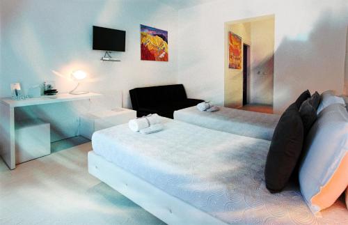 Postel nebo postele na pokoji v ubytování Palco Rooms&Suites