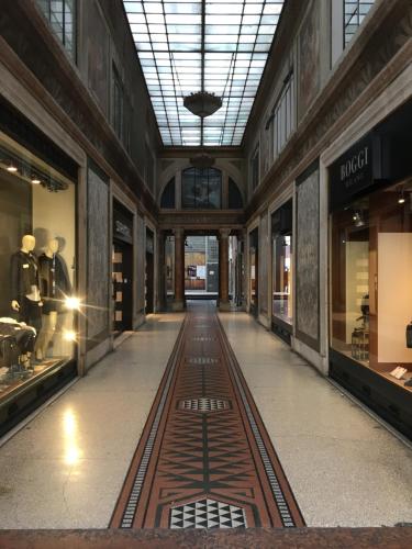 a hallway in a building with windows and a track on the floor at Casa Marchiodi in Trento