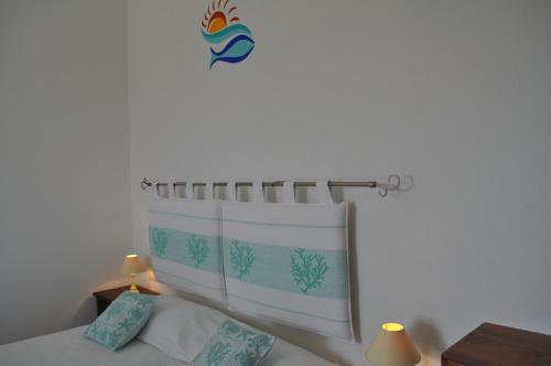 a bedroom with a bed with a curtain on the wall at La Striscia Larga in San Pasquale