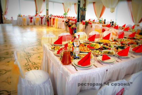 a long table with plates of food on it at 4 Seasons in Boryspilʼ