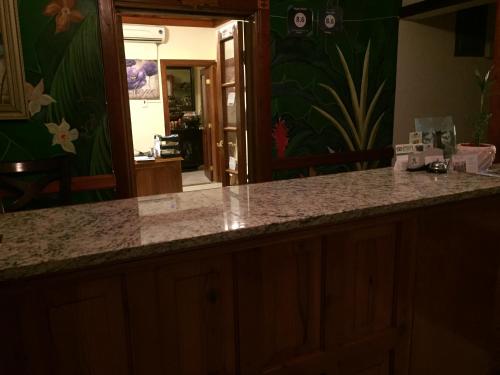 a kitchen with a counter top and a mirror at Rayon Hotel in Negril