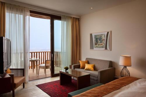 a hotel room with a bed and a living room at Beresheet by Isrotel Exclusive in Mitzpe Ramon
