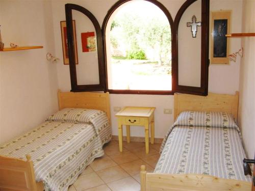 Ένα ή περισσότερα κρεβάτια σε δωμάτιο στο Villa Bruna