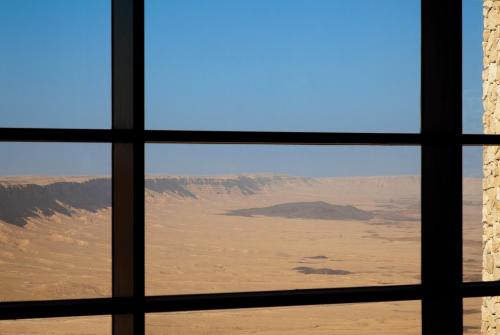 a view of the desert from a window at Beresheet by Isrotel Exclusive in Mitzpe Ramon