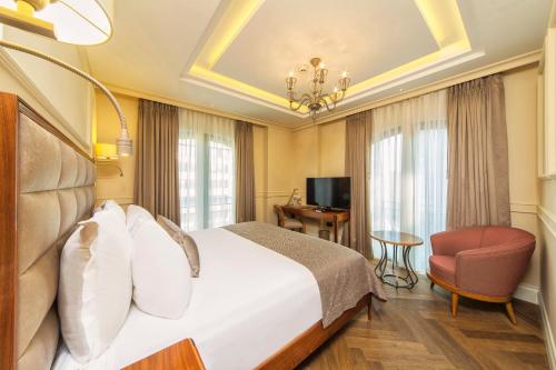 a hotel room with a bed and a chair at Hotel Morione & Spa Center in Istanbul