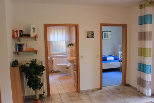 a room with a bathroom and a bedroom with a bed at Ferienwohnungen Akzent in Papenburg