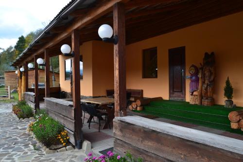 a porch of a house with a table and chairs at Fortuna in Lazeshchyna