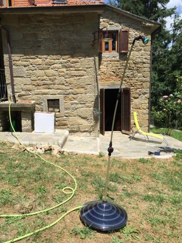 a garden mower in the grass in front of a building at Casa Martino in Villa