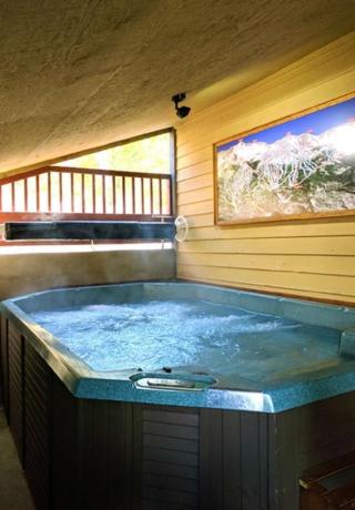 a large blue tub in a room with a window at Breck Inn in Breckenridge