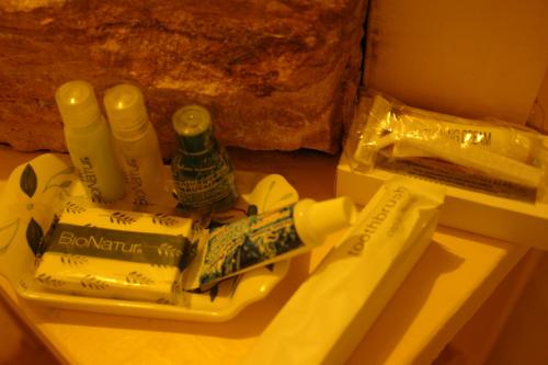 a pile of toothbrushes and a bottle of alcohol on a table at Hotel Posada Primavera in San Cristóbal de Las Casas
