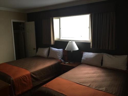 Katil atau katil-katil dalam bilik di Seaside Motel