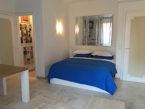 カンヌにあるParc De La Croisetteのベッドルーム1室(青いシーツと枕のベッド1台付)