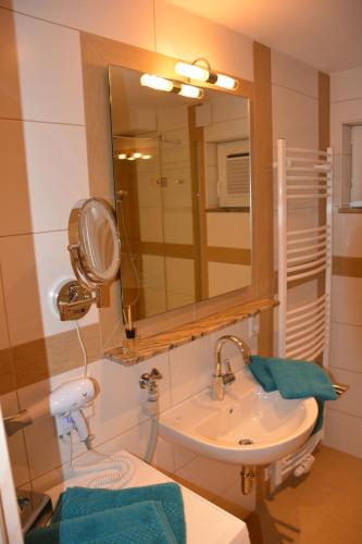 a bathroom with a sink and a mirror at Villa Müsli in Dettingen an der Iller
