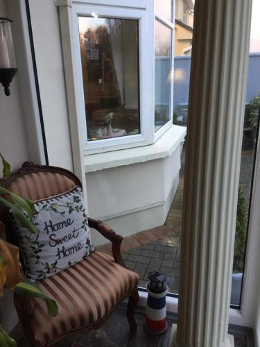 a porch with a chair and a window at Maureen's Bed and Breakfast in Tralee