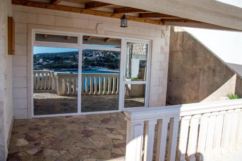 a house with a balcony with sliding glass doors at Vila Vujošević in Utjeha