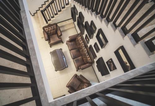 an overhead view of a hallway with chairs and stairs at Rediu Hotel & Restaurant in Botoşani