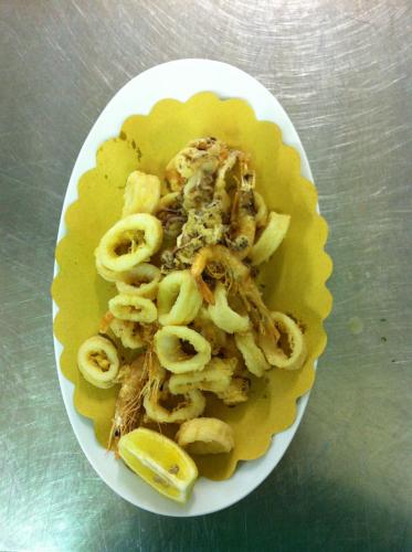 a plate of food with pasta on a table at Hotel Grifone in Principina a Mare