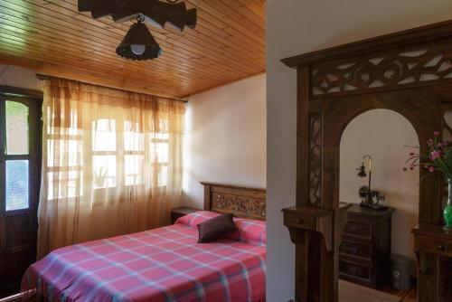 a bedroom with a bed with a checkered blanket at Tonsuca in Iza