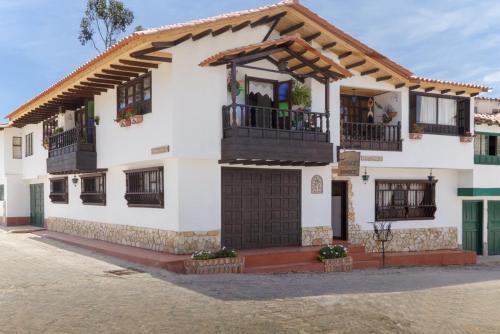 a large white house with a balcony at Tonsuca in Iza