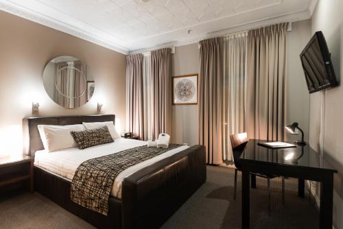 A bed or beds in a room at Clarendon Hotel