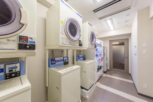 a hospital room with a washer and dryer at Hotel M's Plus Shijo Omiya in Kyoto
