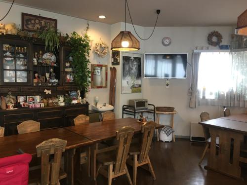 a dining room with a wooden table and chairs at Fujiyoshi in Nozawa Onsen