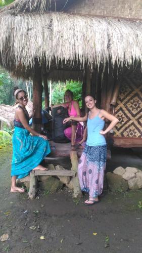 a group of people standing in front of a hut at Bali Jungle Resort in Tegalalang