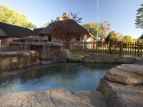 a pool of water in a yard with a fence at Whispering Waters in Fort Nottingham