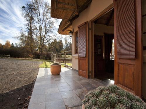 a porch of a house with a door and a courtyard at Whispering Waters in Fort Nottingham