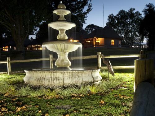 a fountain in the grass in a park at Whispering Waters in Fort Nottingham