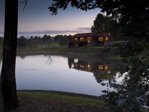 a house sitting next to a body of water at Whispering Waters in Fort Nottingham
