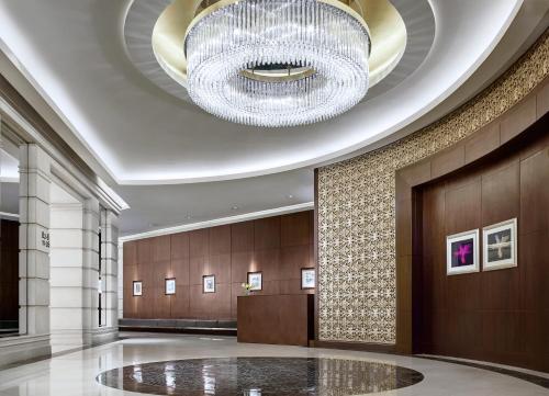 a lobby with a large chandelier in a building at Cordis, Hong Kong in Hong Kong