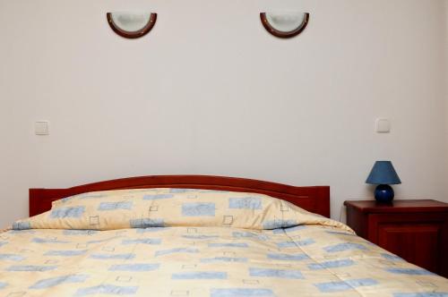 a bedroom with a bed and two mirrors on the wall at Kris Guest House in Devin