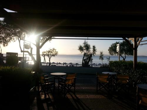 a view of the ocean from a restaurant with tables and chairs at Karfas Bay View in Karfas