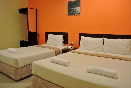 Postel nebo postele na pokoji v ubytování Wau Hotel & Cafe