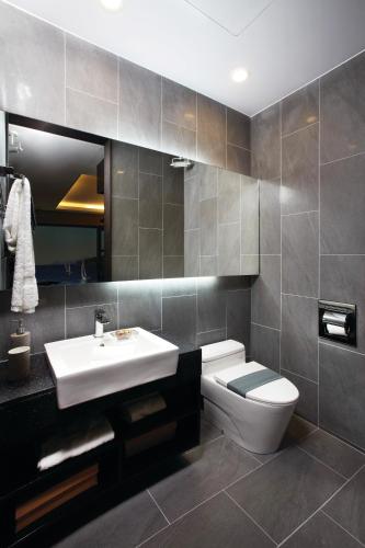 a bathroom with a white sink and a toilet at Royal Emporium Incheon Airport in Incheon