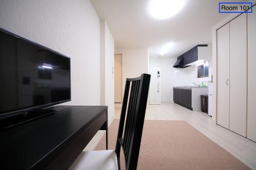 a living room with a large flat screen tv at Apartment Heights HANA in Sakai