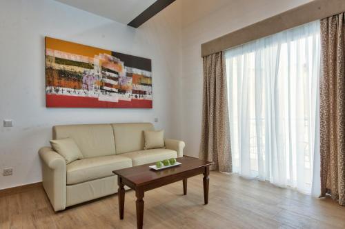 a living room with a couch and a table at Palazzo Violetta in Sliema