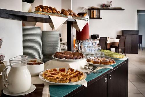 a buffet with pies and pastries on a table at Terradimare Resort&Spa in San Teodoro