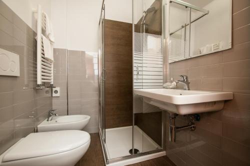 a bathroom with a toilet and a sink and a shower at La Vecchia Fattoria in Loreto