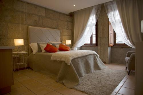 a bedroom with a large bed with red pillows at Turra Residence in Porto