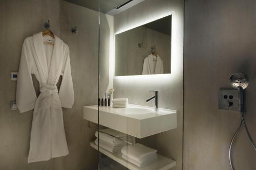 a bathroom with a mirror and a towel rack at Drawing Hotel in Paris