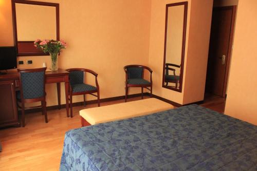 Ένα ή περισσότερα κρεβάτια σε δωμάτιο στο Hotel Terminal