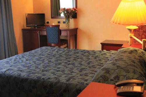 Ένα ή περισσότερα κρεβάτια σε δωμάτιο στο Hotel Terminal
